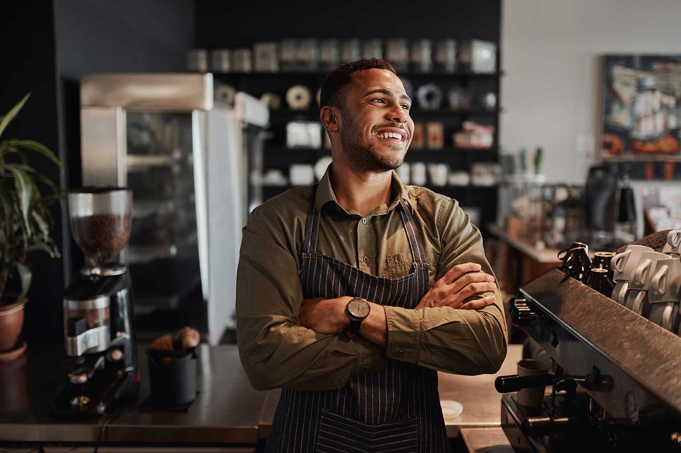 shutterstock_1673899597 smiling man business owner in coffee shop